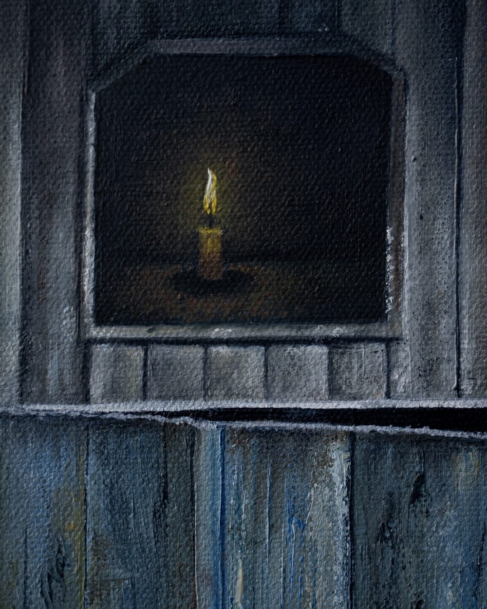 Detail of Inocencia: a candle burning in a dark window.