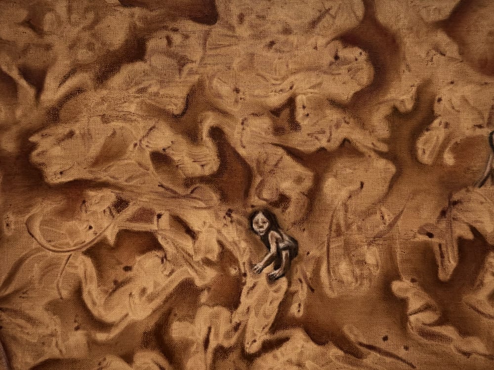 Detail of Pachamama: a small figure held in the swirling surface.
