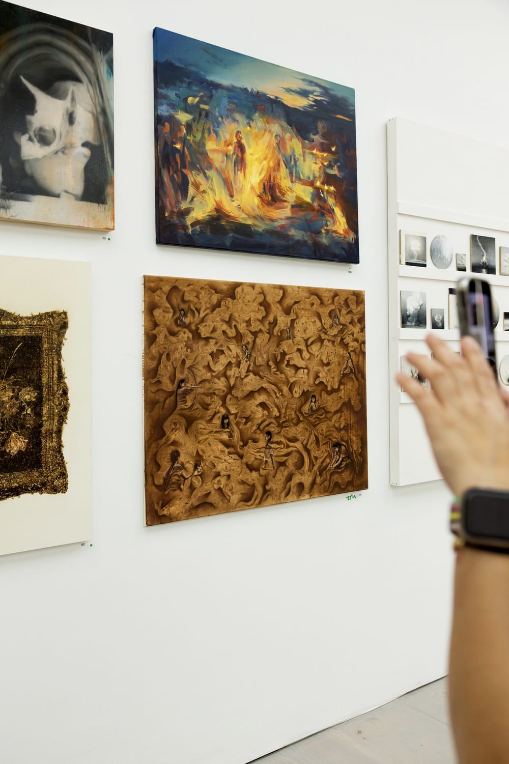 A visitor photographing Pachamama at Saatchi Gallery.